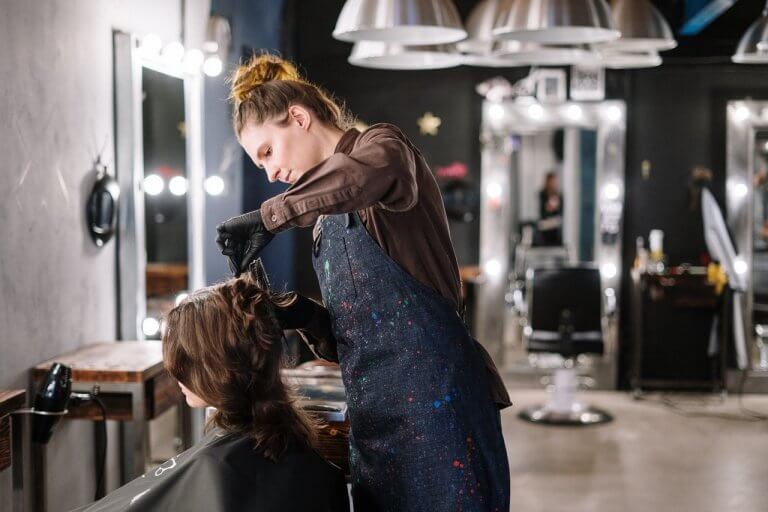 Woman giving a haircut.