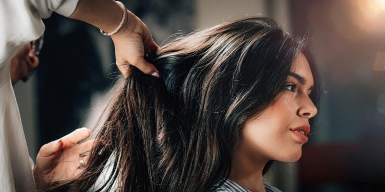 woman getting her hair done by a stylist