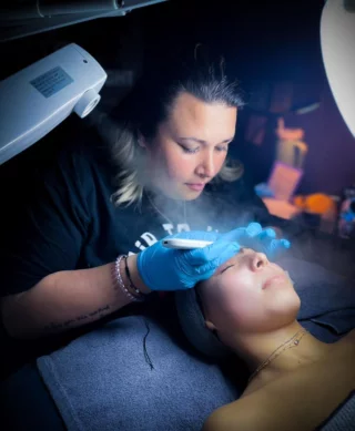 Esthetician performing facial treatment